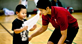 Staff gives young boy certificate